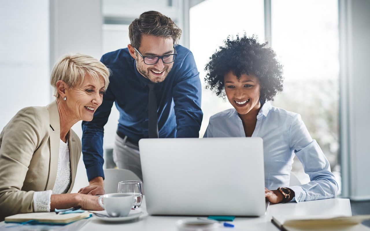 Shot of a group of businesspeople working together on a laptop